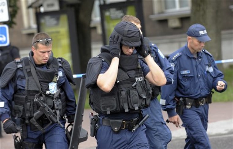 Police officers are seen Thursday after storming the Defense Ministry building in Tallinn, Estonia, where a gunman opened fire, tried to take hostages on Thursday, but was fatally shot by police.